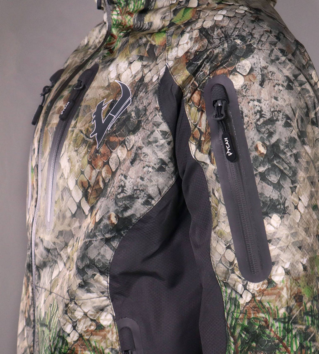 Close-up of the zippered sleeve pocket on the Vycah Ventral Rain Jacket in Fall camo