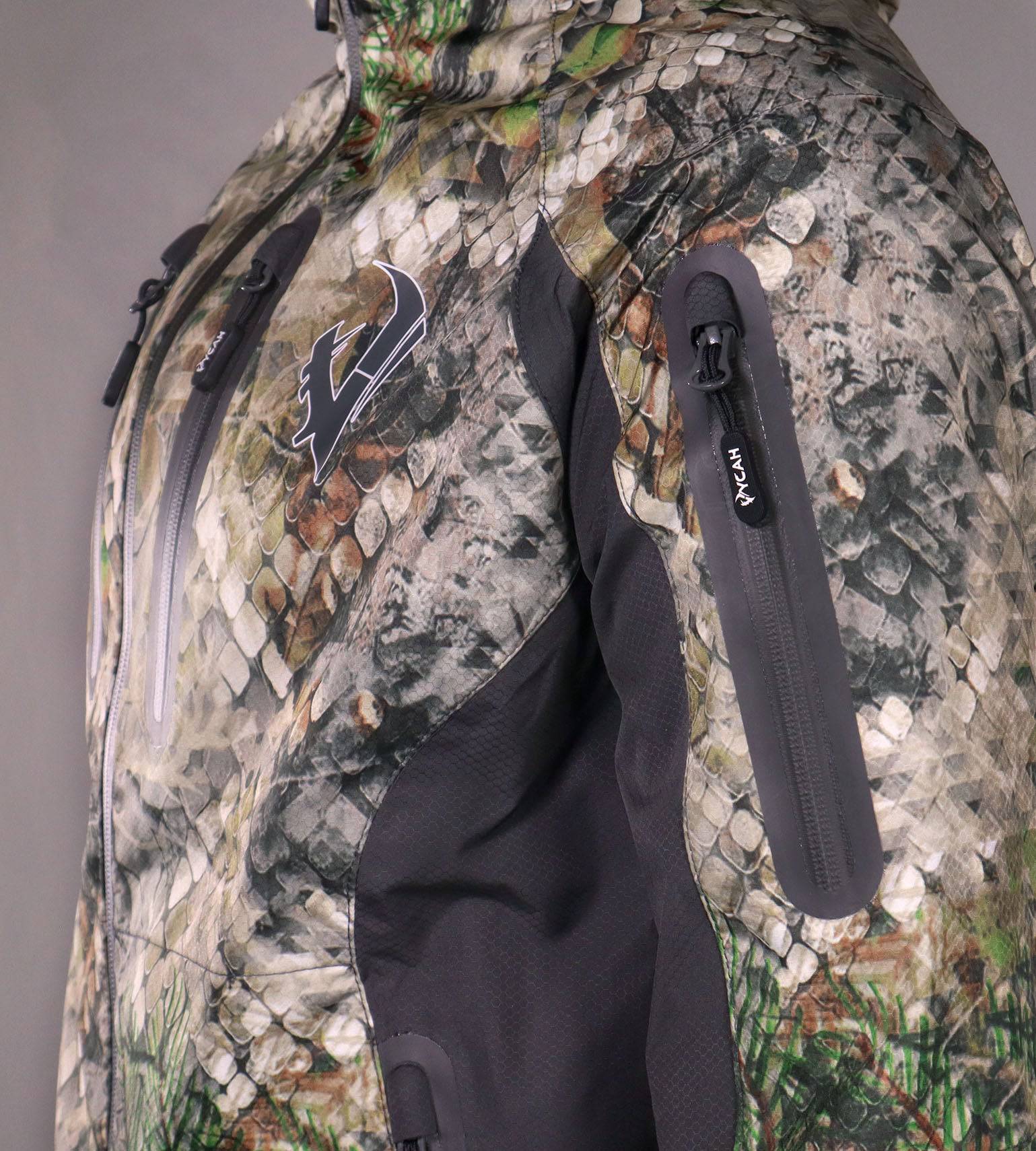 Close-up of the zippered sleeve pocket on the Vycah Ventral Rain Jacket in Fall camo