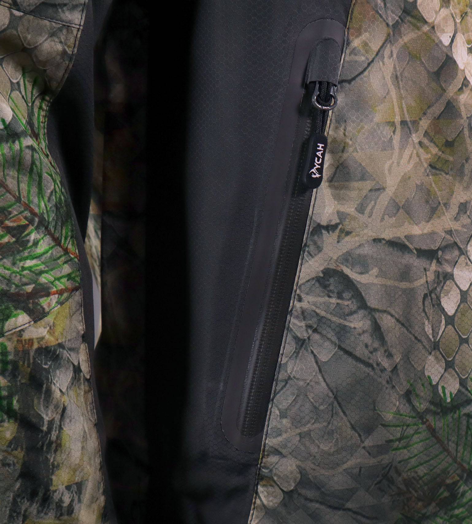 Close-up of a waterproof matte zipper with shed housing on the Vycah Ventral Rain Jacket